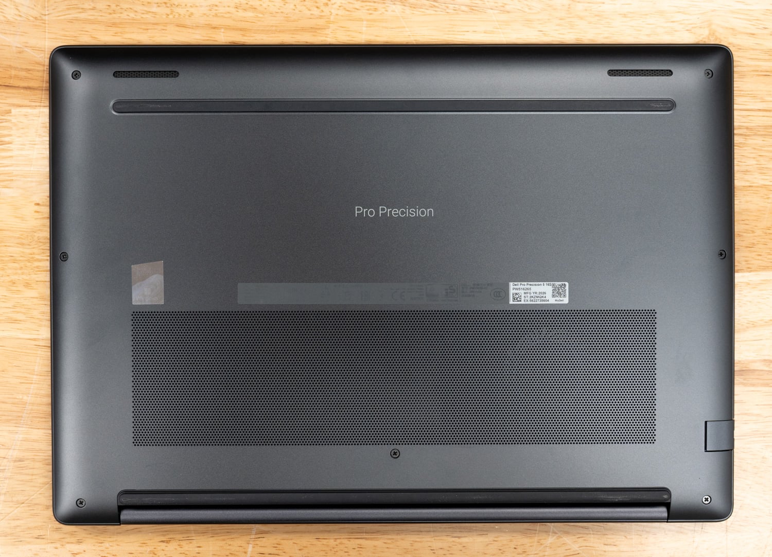 Dell Pro Precision 5 16s AMD bottom cover exterior showing the ventilation intake and rubber feet