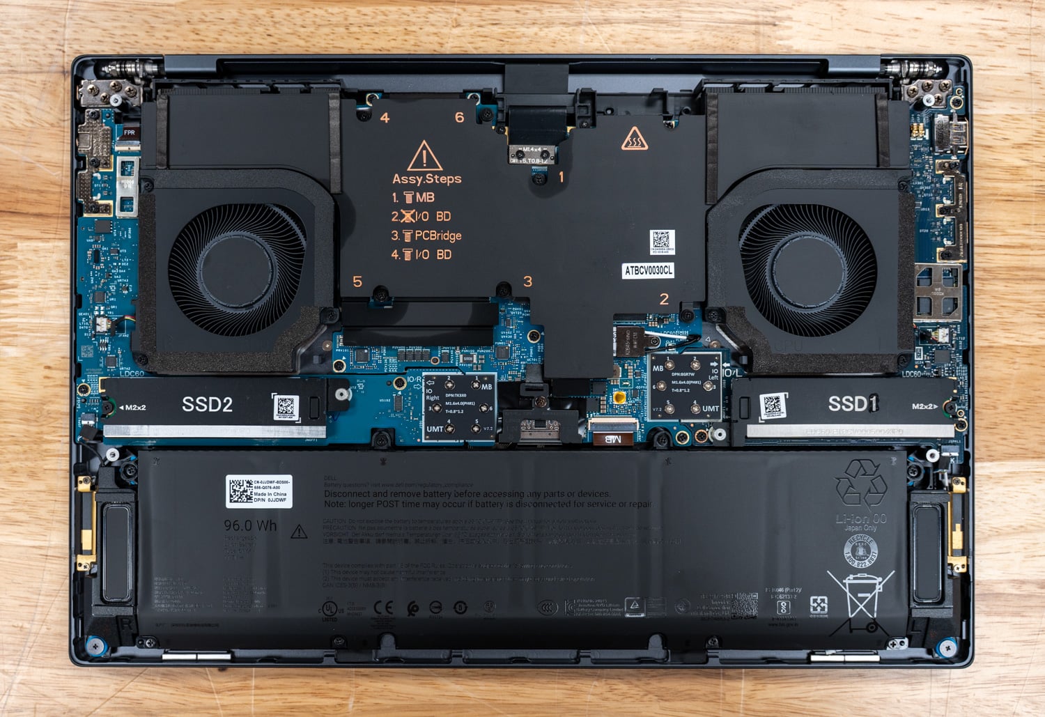 Dell Pro Precision 7 16 internals showing dual fans, two M.2 SSD slots and the 96Wh battery