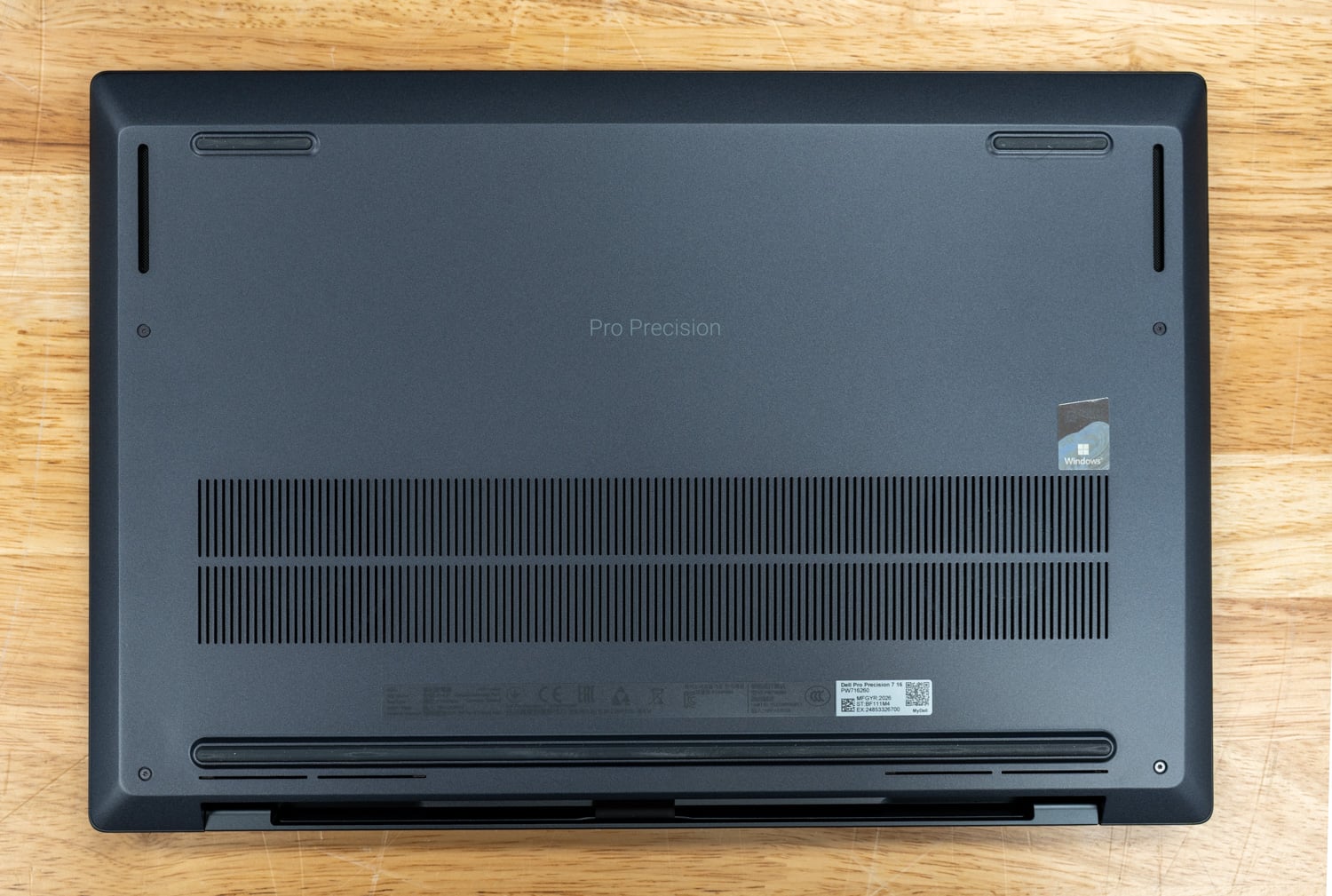 Underside of the Dell Pro Precision 7 16 with rear exhaust vents and Pro Precision branding