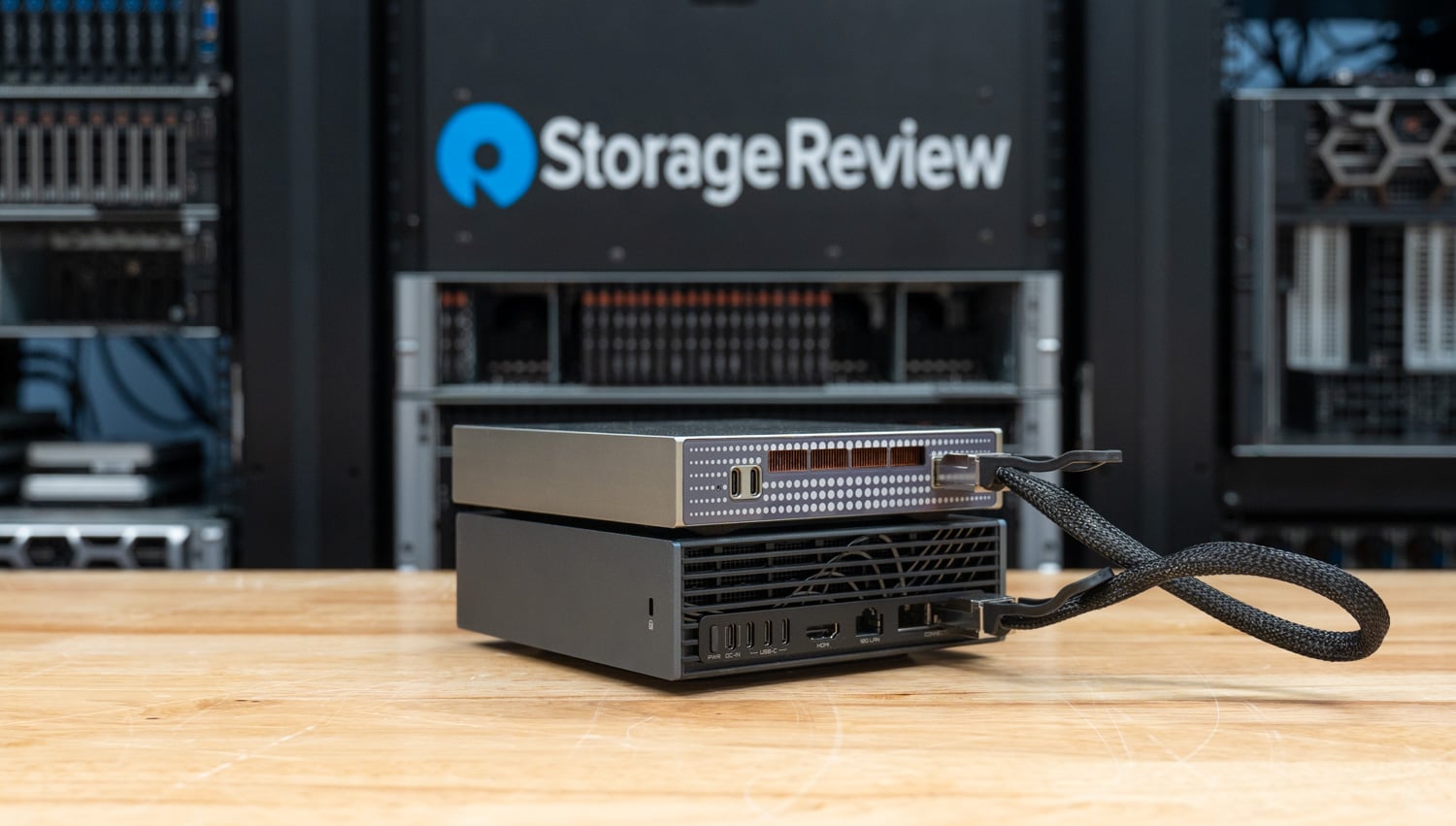Rear view of the GP Spark connected to the DGX Spark ConnectX port with a 100GbE DAC cable, copper heatsink visible through the vents