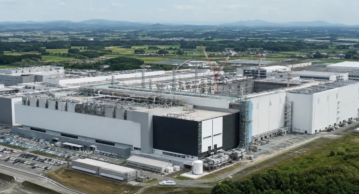 Aerial view of the Kioxia and Sandisk joint venture fab campus in Japan, with new construction underway alongside the existing plant