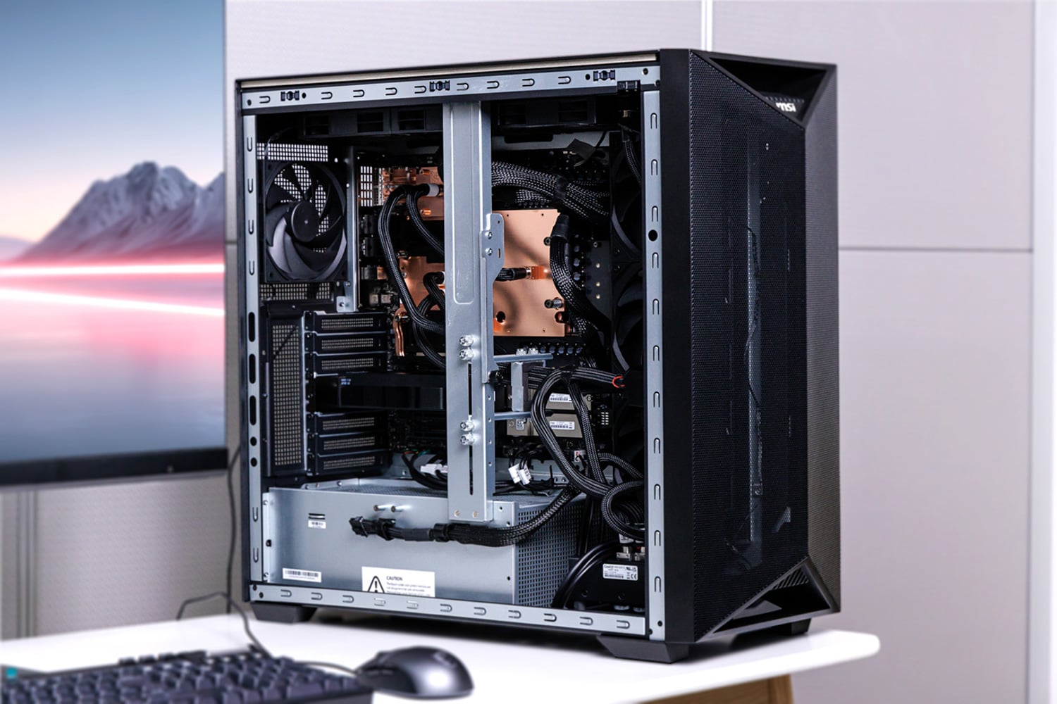 MSI XpertStation WS300 on a desk with the side panel off, copper cold plates and liquid cooling visible