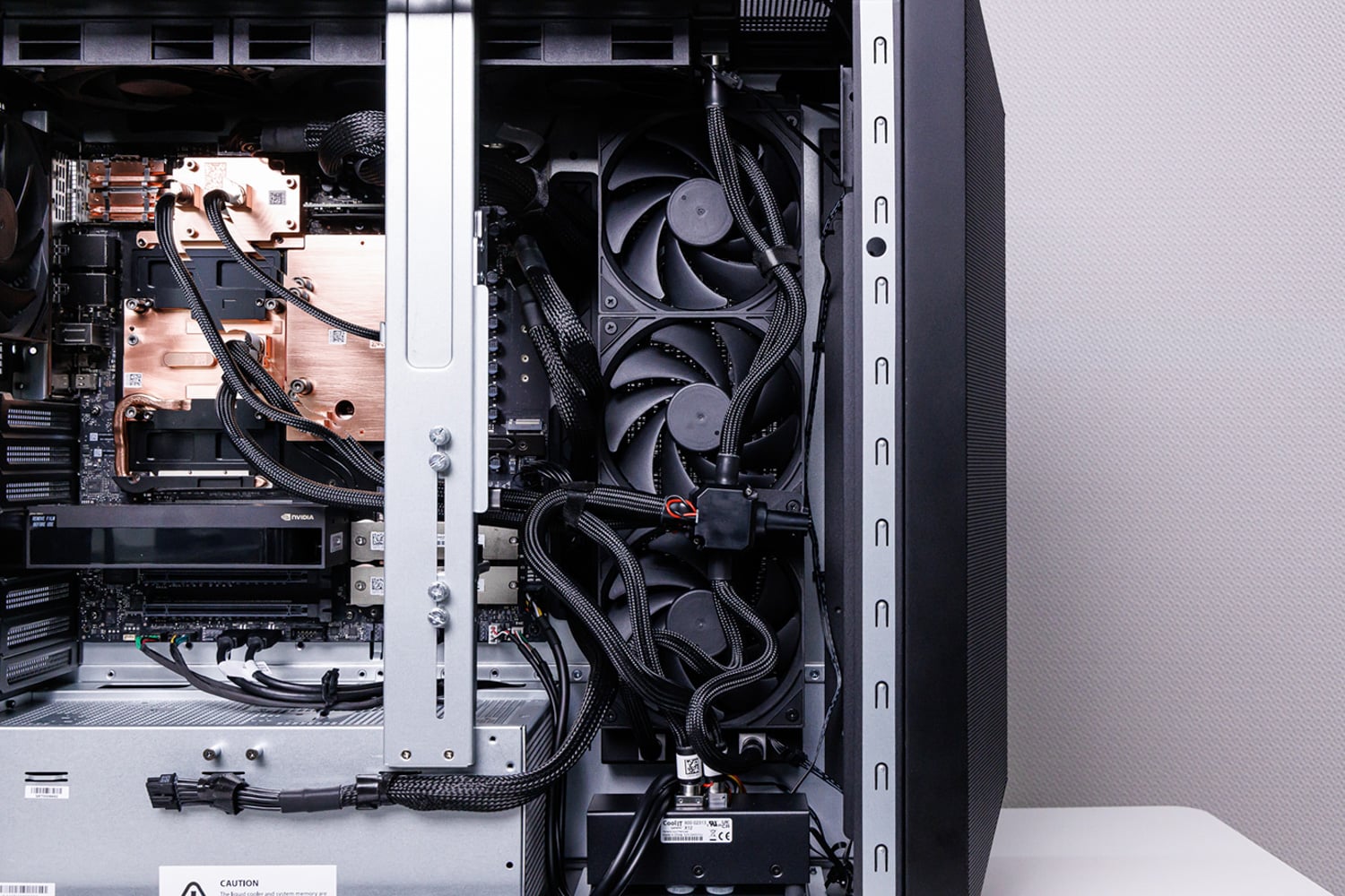 Liquid cooling radiator, fans, and braided tubing inside the MSI XpertStation WS300