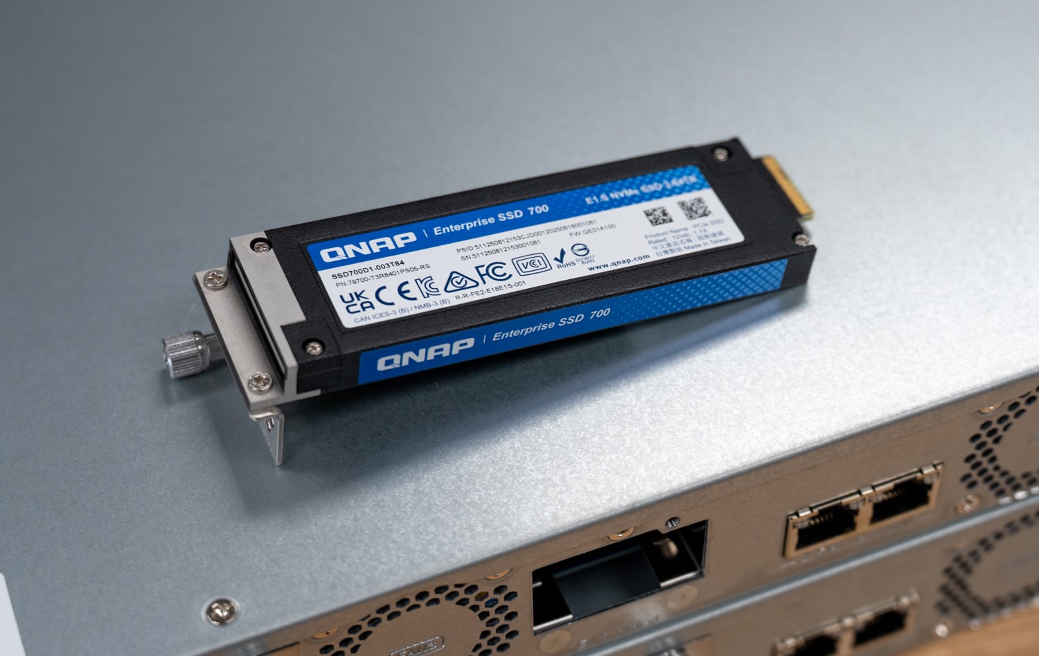 QNAP Enterprise SSD 700 E1.S drive in its carrier, used as cache in the TS-h765eU high availability cluster