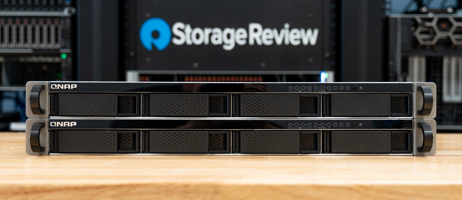 Two QNAP TS-h765eU 1U short-depth NAS units stacked in the StorageReview lab, the pair used to build the high availability cluster