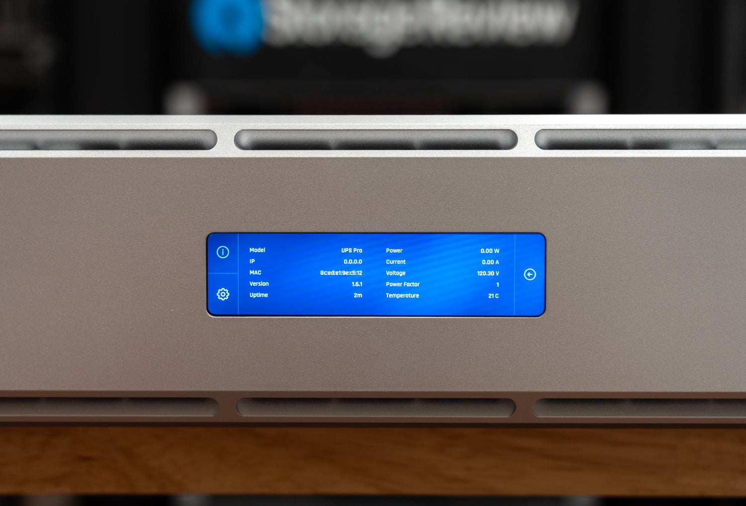 Device info screen on the UPS 2U Pro touchscreen with firmware version, voltage, and temperature