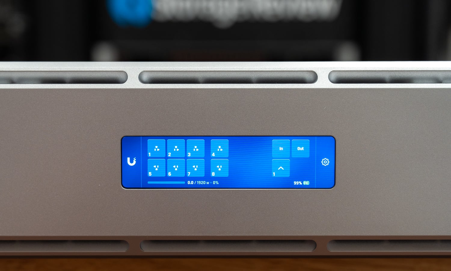 Outlet status grid on the UPS 2U Pro touchscreen with all eight outlets, load, and battery charge