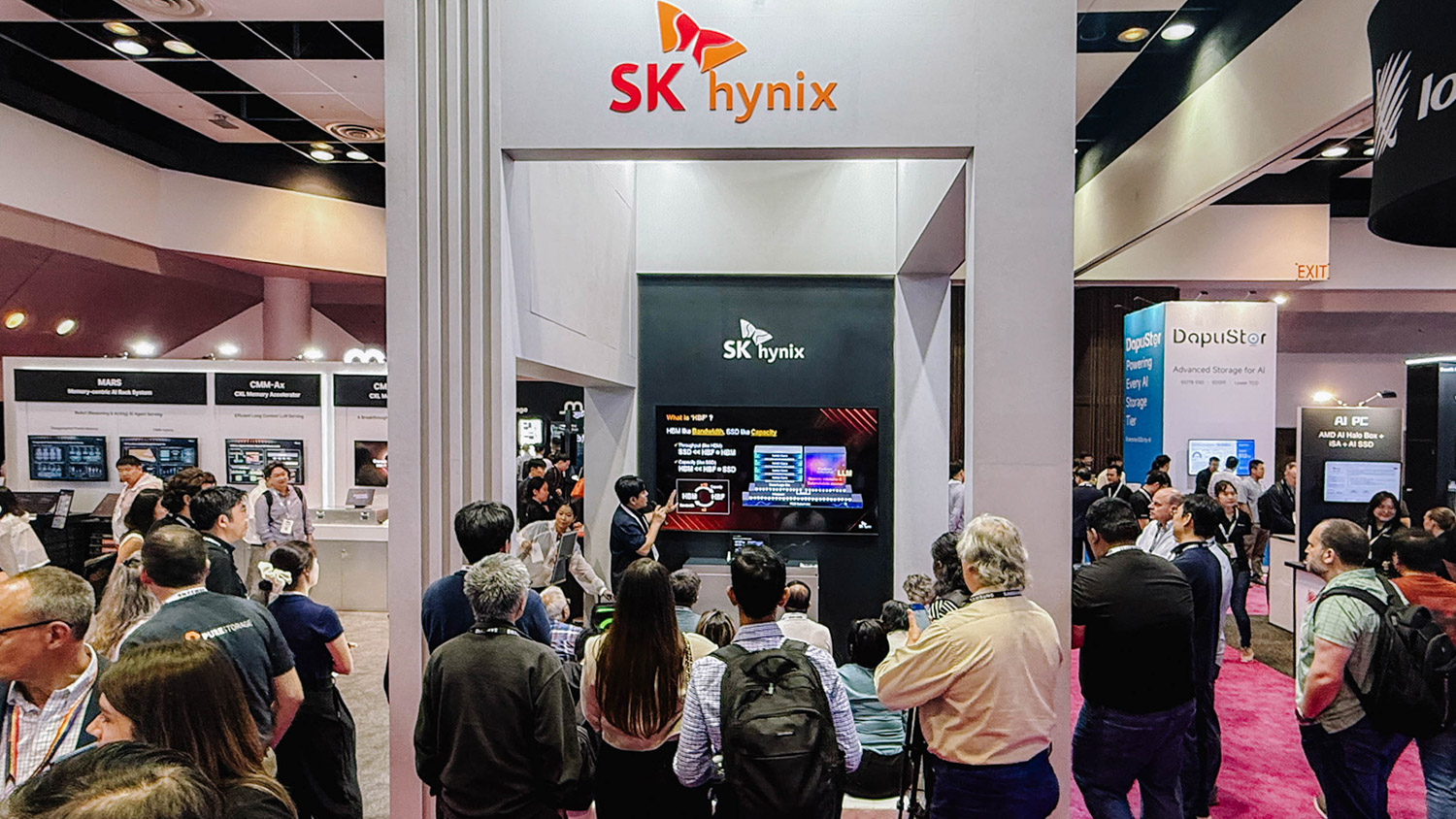 Crowd at the SK hynix FMS 2026 booth watching a What is HBF presentation on the main screen