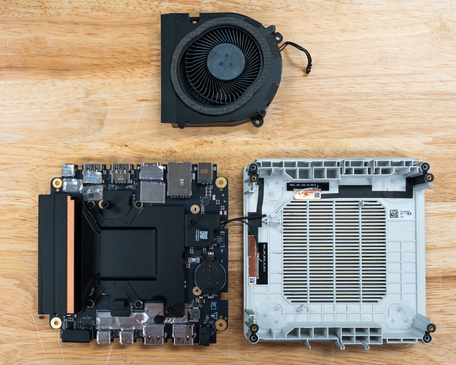 ASUS Ascent QN10 teardown with the cooling fan removed, showing the vapor chamber and mainboard