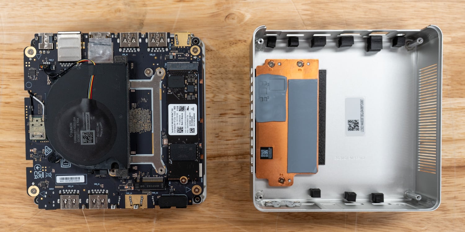 ASUS Ascent QN10 opened, with the mainboard and fan beside the chassis shell and its copper SSD thermal pads