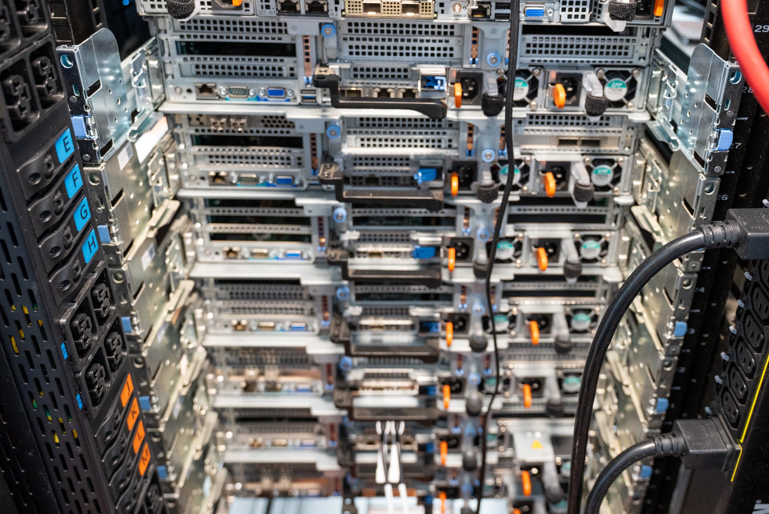 Eaton HDXL Rack PDU installed at the rear of a rack of Dell PowerEdge servers with power cords connected