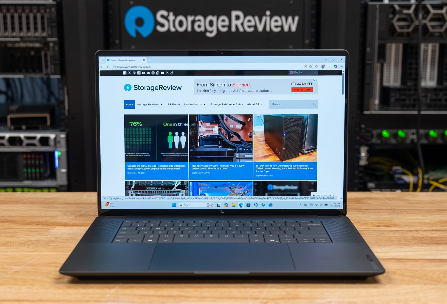 HP ZBook Ultra G3a 16 open and facing the camera on the StorageReview lab bench in front of a rack of servers
