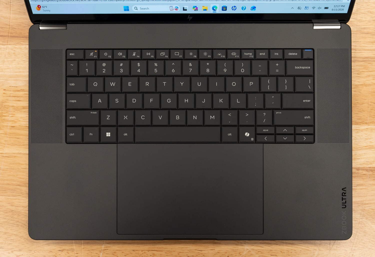 Top-down view of the HP ZBook Ultra G3a 16 keyboard deck with backlit keys, a large glass trackpad, and ZBOOK ULTRA branding on the palm rest