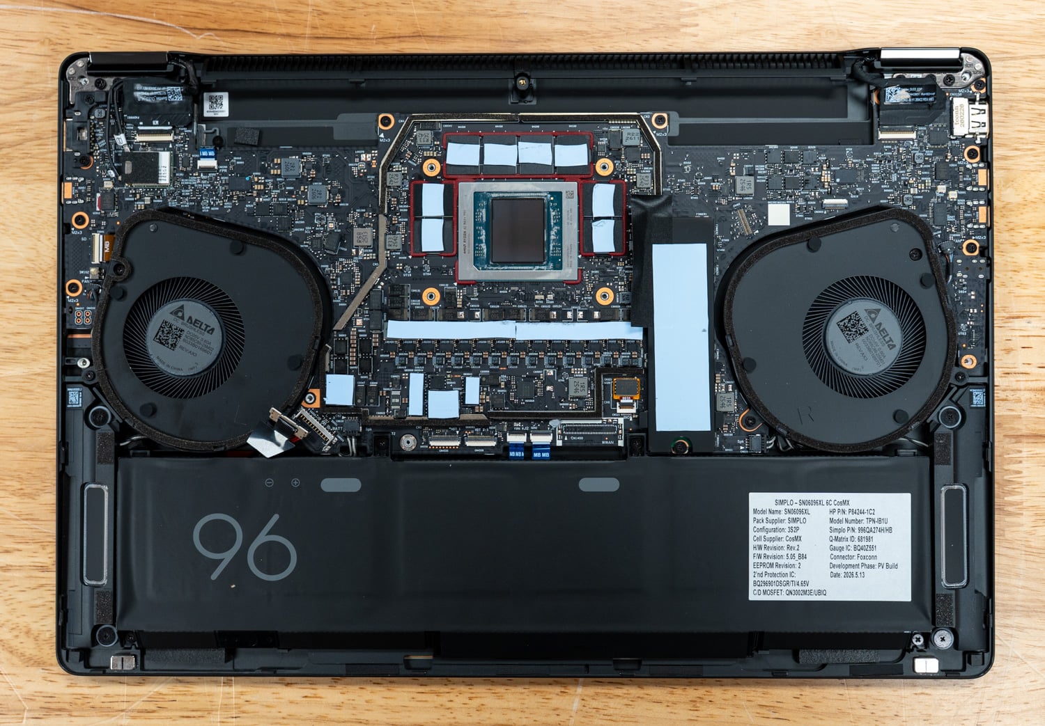 HP ZBook Ultra G3a 16 with the heat spreader removed, exposing the SoC and LPDDR5X packages between the dual Delta fans, with the single M.2 SSD slot and 96Wh battery below