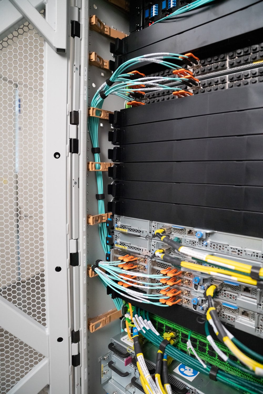 Rear of a single-rack AWS Outposts cabinet with fiber patching into a top-of-rack switch above a column of compute sleds (AWS image)