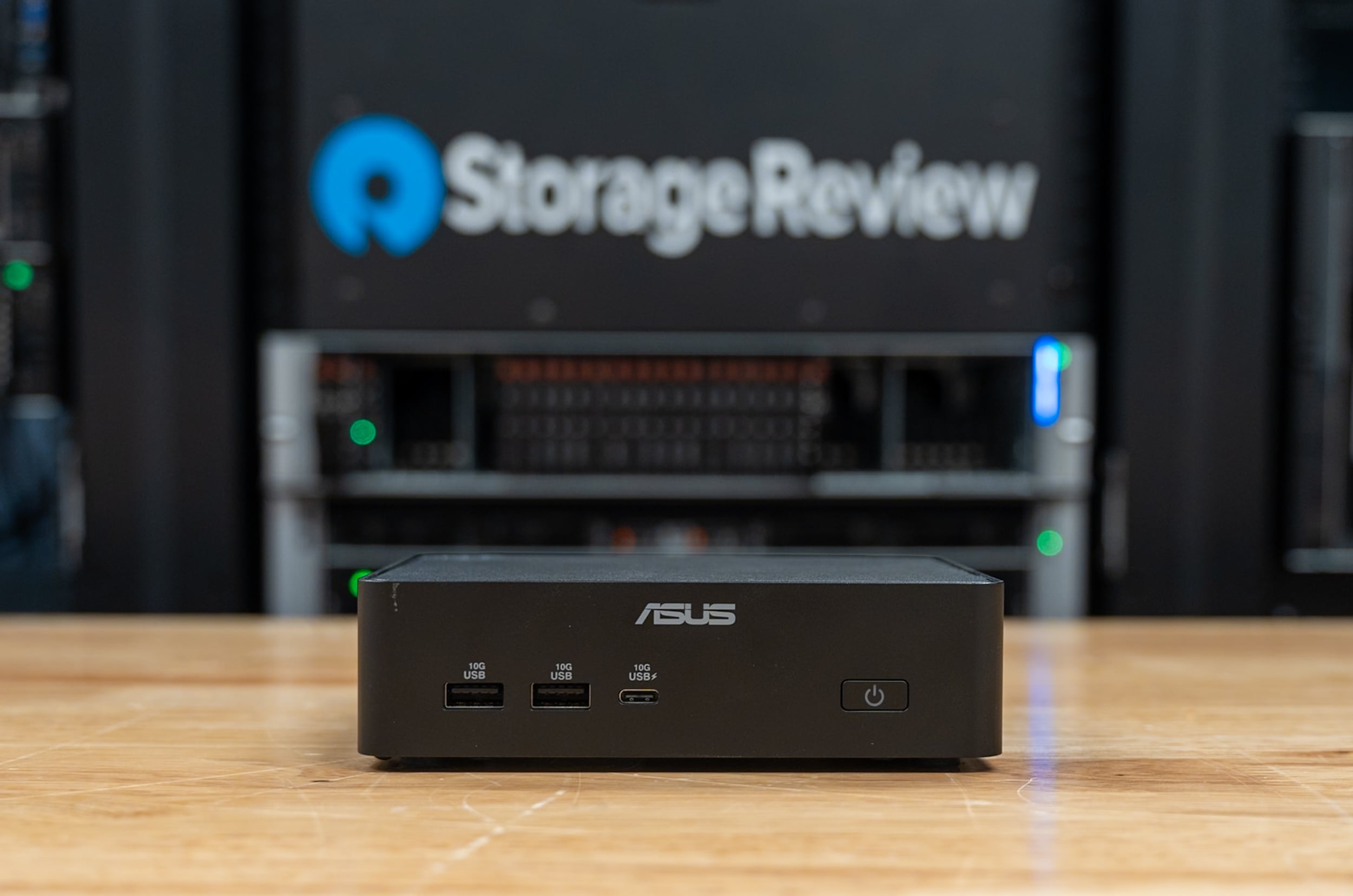 ASUS NUC 16 Pro front view in the StorageReview lab, showing the two USB-A 10Gbps ports, the USB-C port, and the power button