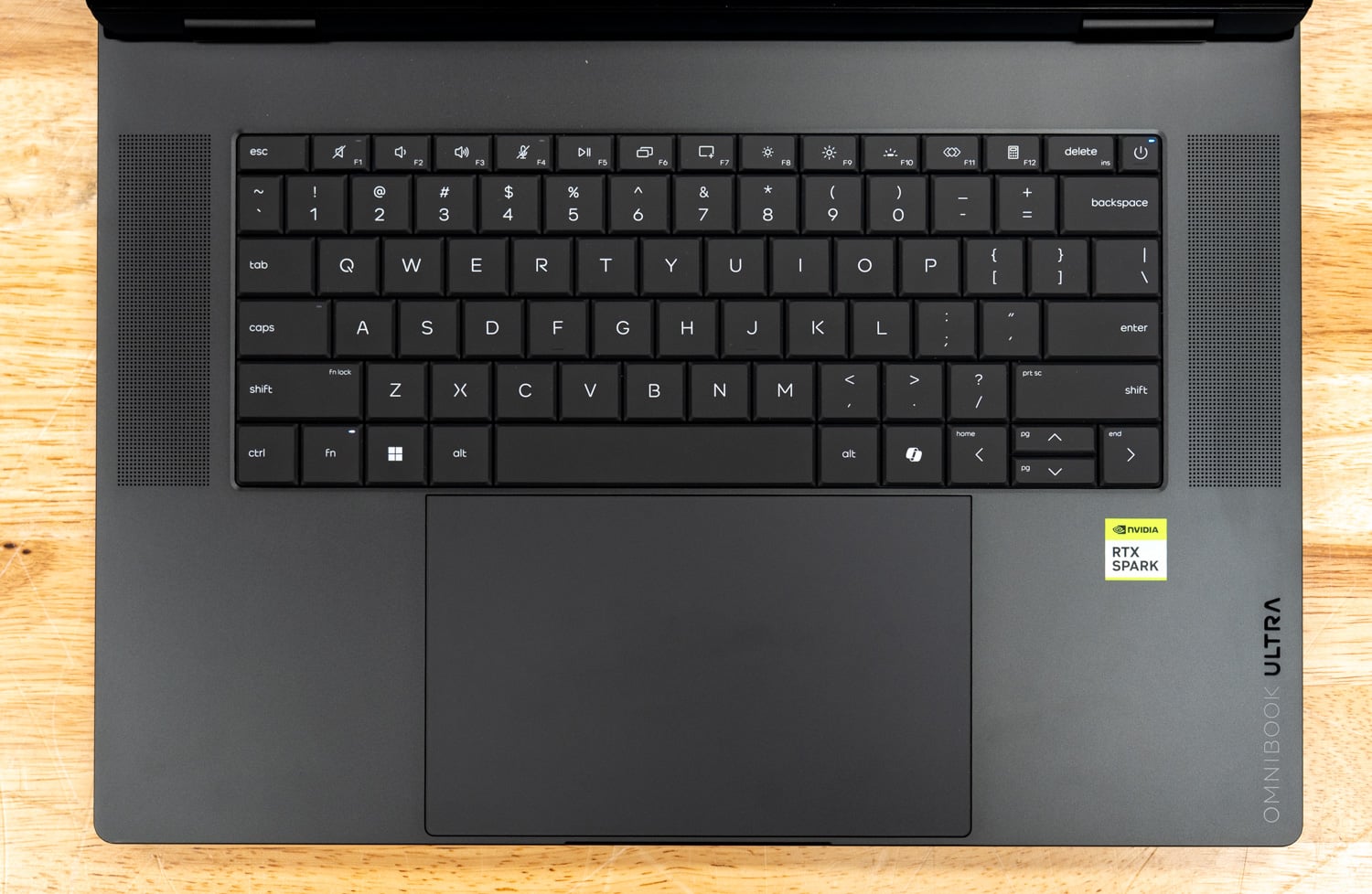 HP OmniBook Ultra 16 keyboard deck with speaker grilles on both sides of the keyboard and the haptic touchpad