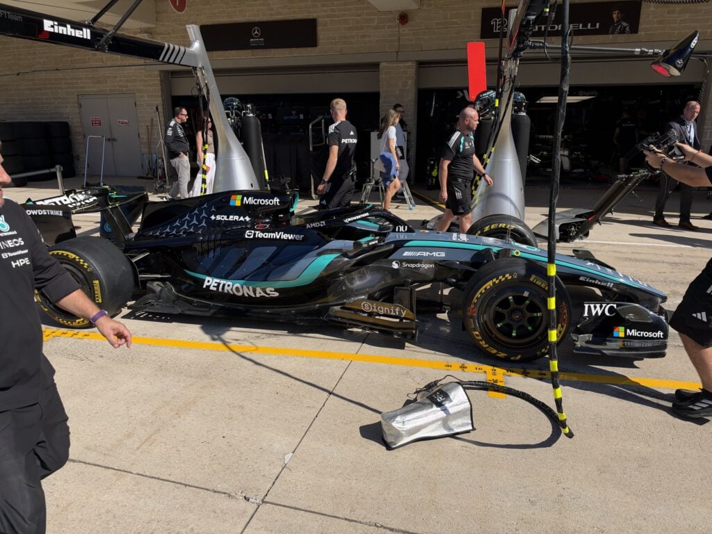 Kimi Antonelli's Mercedes W17 outside the garage at COTA between FP1 and FP2, mechanics working around the car in the Austin livery
