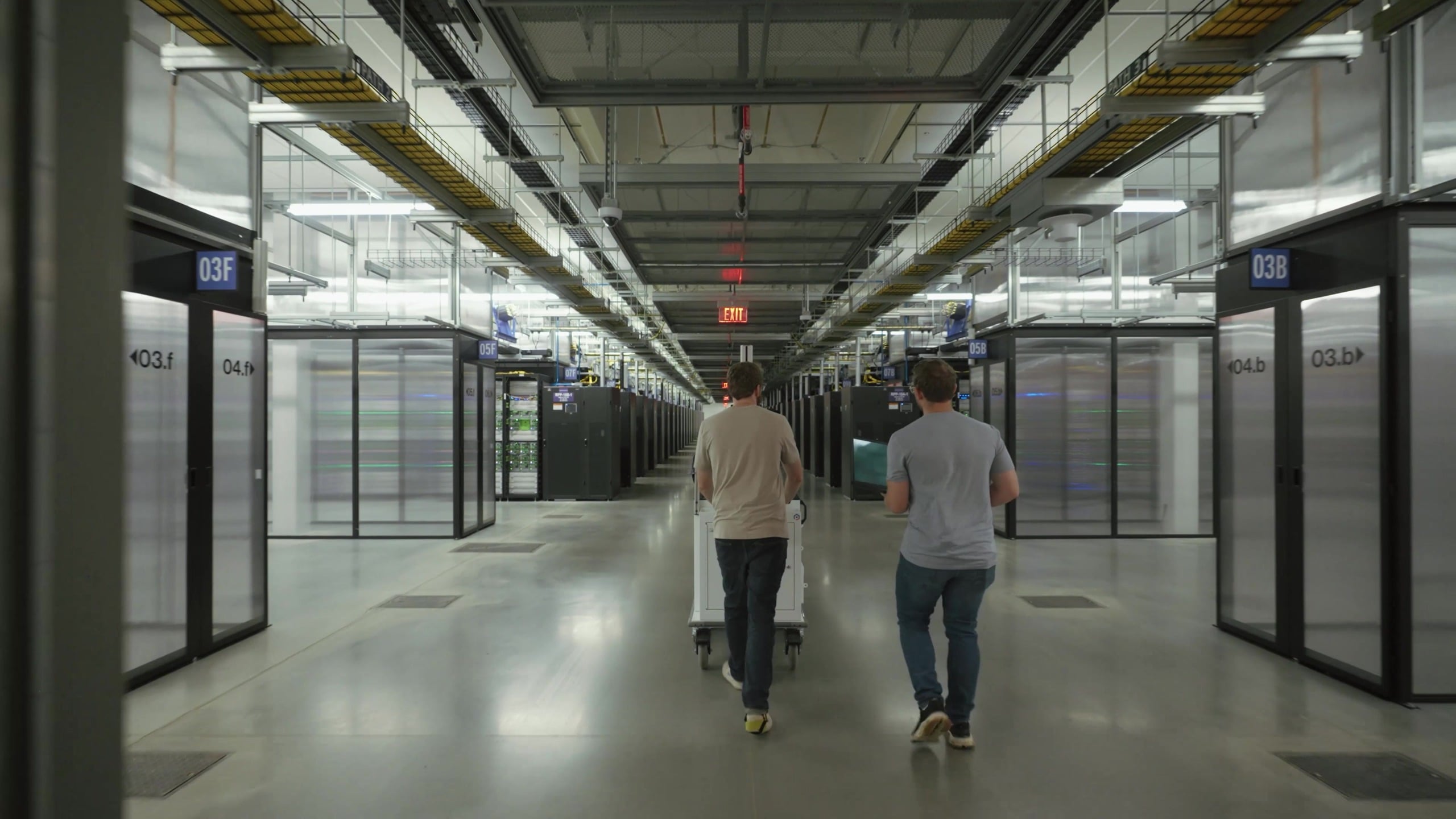 Technicians walking a corridor between data halls at Meta's Prometheus site in New Albany