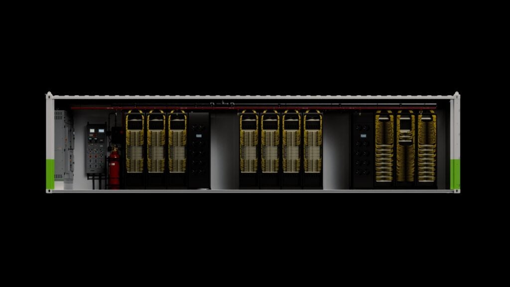 NVIDIA DSX POD render: a shipping container cut away to show three groups of Vera Rubin racks with yellow cabling, power distribution and fire suppression cabinets at the left end