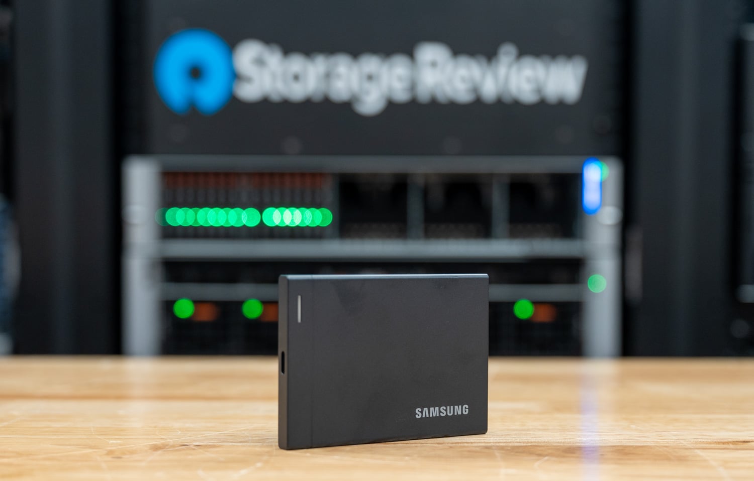 Samsung Portable SSD P9 2TB standing on the StorageReview lab bench with its metal shell and Samsung logo facing the camera