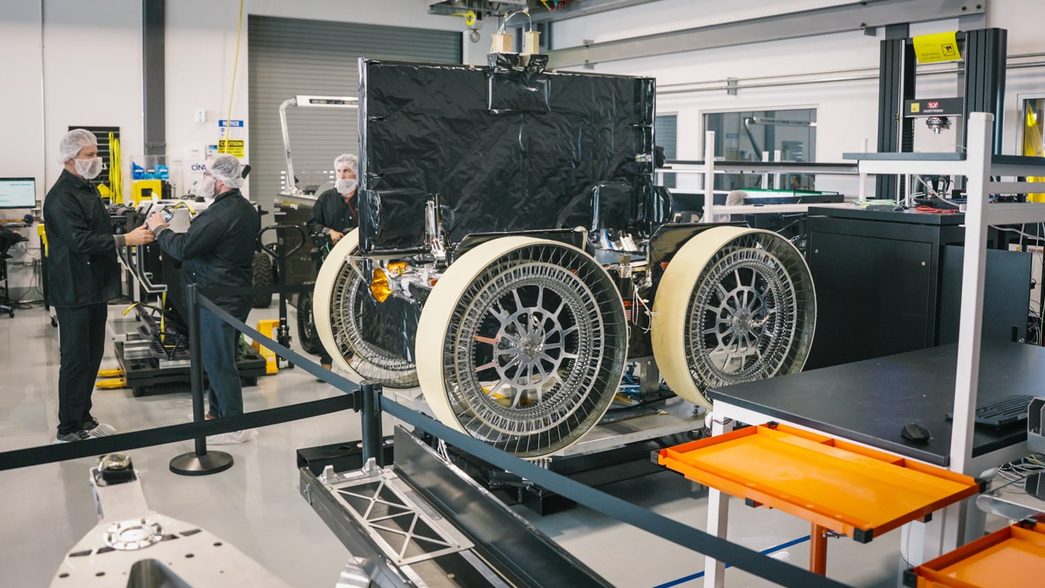 Astrolab FLIP lunar rover in the clean room with its large Venturi wheels and the back of its vertical solar panel, ahead of its late 2026 launch carrying HPE Spaceborne Computer-4