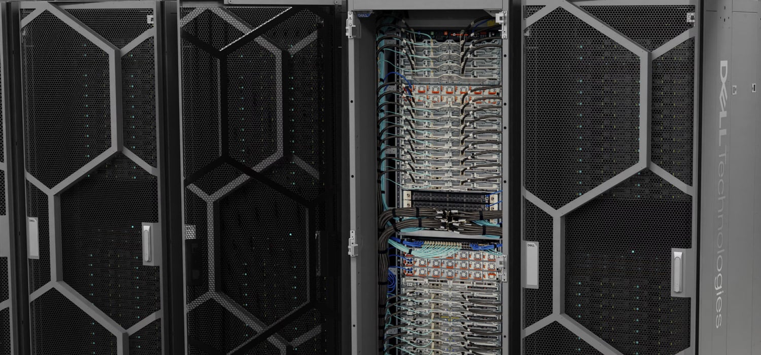 Dell Integrated Rack Scalable Systems cabinets with the center rack open to show a column of PowerEdge M7725 sleds and cabling, the rack-scale hardware behind the Dell AI Factory with NVIDIA