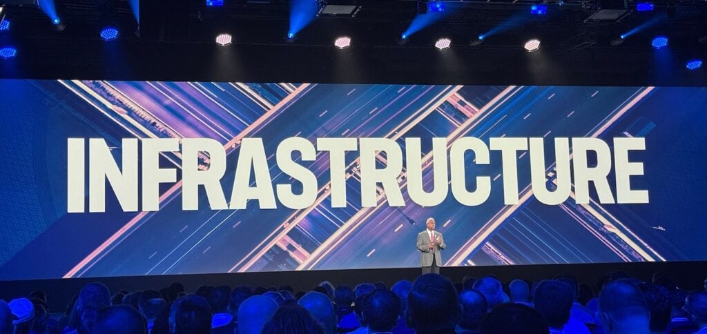 NetApp INSIGHT 2026 keynote stage in Las Vegas with a presenter in front of a wall-sized Infrastructure graphic, where NetApp Novus was announced
